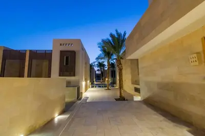 a building with a courtyard with a palm tree at Nayah Stays, Amazing villa with private pool & 5 master suites in Hurghada