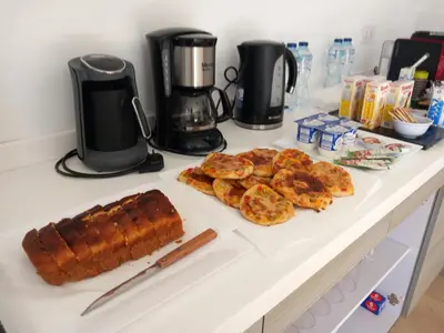 a counter with bread and other food on it at Nayah Stays, Amazing villa with private pool & 5 master suites in Hurghada