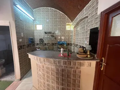 a bathroom with a counter in the middle of a room at Hamd Nubian Guest House in Aswan