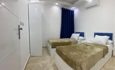 a room with two beds and a door to a bedroom at selena bay in Hurghada