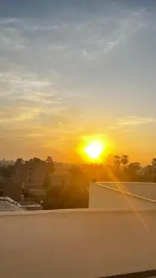 a sunset seen from the roof of a building at Masa House Luxor in Luxor
