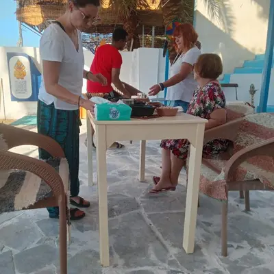 a group of people preparing food on a table at hooly nubian in Aswan