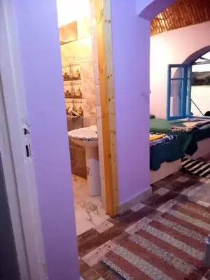 a room with a bathroom with a sink and a bed at hooly nubian in Aswan