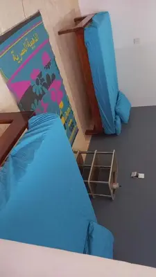 a bedroom with a blue bed and a play structure at Rema Nubian Guest House in Aswan