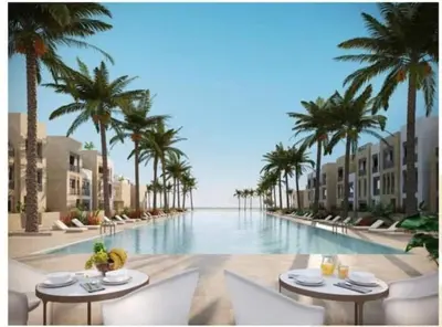 a view of a pool with palm trees and tables at Mangarovy El Gouna in Hurghada