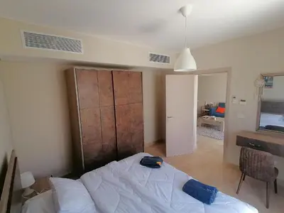 a bedroom with a bed with a hat on it at Mangarovy El Gouna in Hurghada