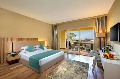 a hotel room with a bed and a balcony at AJIRA Resort Sahl Hasheesh in Hurghada