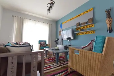 a living room with a couch and a table at Lagoon View Penthouse - El Gouna Paradise Escape in Hurghada