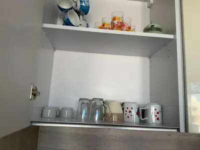 a kitchen shelf with cups and mugs on it at Elgouna Hurghada egypt mangroovy in Hurghada