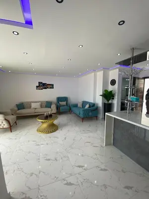 a large living room with couches and a table at Blue Whale Hurghada Beach Front Apartments City Centre in Hurghada