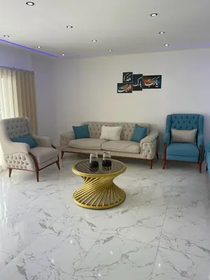 a living room with couches and a gold coffee table at Blue Whale Hurghada Beach Front Apartments City Centre in Hurghada