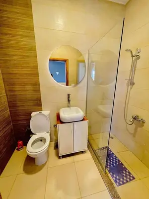 a bathroom with a toilet and a sink and a shower at Ali Luxury Villa in Luxor