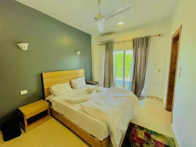 a bedroom with a large bed and a window at Ali Luxury Villa in Luxor