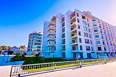 a large white building with a fence in front of it at شقة علي البحر 2 in Hurghada