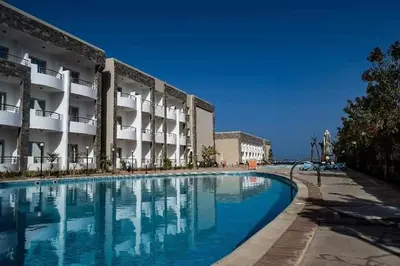 a swimming pool in front of a building at Compound cecelia in Hurghada
