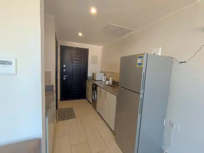 a kitchen with a stainless steel refrigerator in a room at Aldau Heights lovely studio in Hurghada