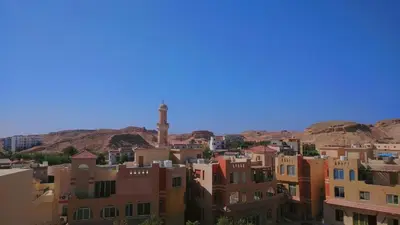 a city with buildings and a clock tower in the distance at Aldau Heights lovely studio in Hurghada