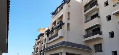 a building with balconies on the side of it at Aldau Heights lovely studio in Hurghada