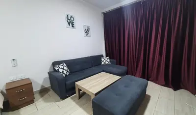 a living room with a couch and a table at Aldau Heights Cozy big studio in Hurghada