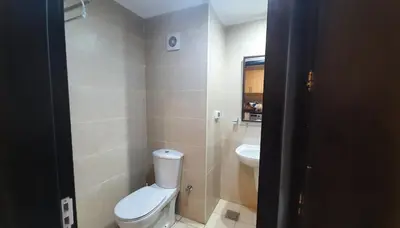 a small bathroom with a toilet and a sink at Aldau Heights Cozy big studio in Hurghada