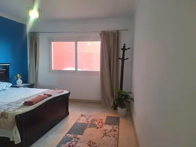 a bedroom with a bed and a window at new marina . your best choice for family in Hurghada