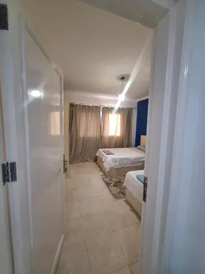 a bathroom with two beds and a shower in a room at new marina . your best choice for family in Hurghada