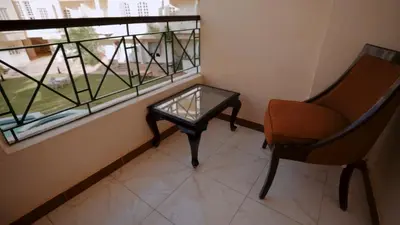 a chair and a table in a room with a window at New Sunset Resort in Aswan