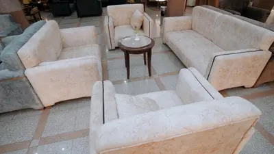 a living room with three couches and a table at New Sunset Resort in Aswan
