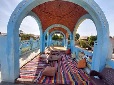 a view of a mosque with a colorful rug in the middle of a building at Mostafa Nubian Guesthouse in Najâ€˜ al MadÄbb