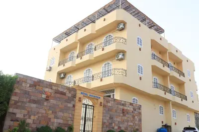 a building with balconies on top of a brick wall at Royal Mountain in Luxor