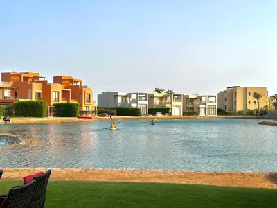 a swimming pool in front of some apartment buildings at Luxury 3BR Townhouse, Tawila, El Gouna, Lagoon & Pool access in Hurghada