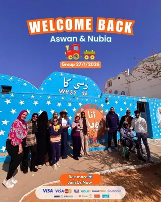 a group of people standing in front of a banner at Nubian Wessy Ka Guest House in Aswan