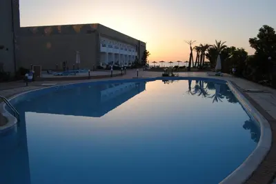 a large swimming pool in front of a building at Cecelia resort in Hurghada