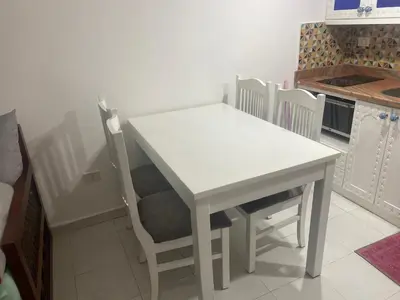 a white table and chairs in a kitchen at One Bedroom with Balcony WI-FI Downtown Sheraton Plaza 226 in Hurghada