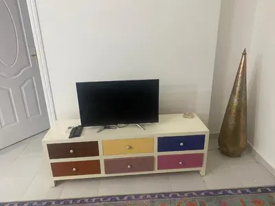 a television on a dresser in a room at One Bedroom with Balcony WI-FI Downtown Sheraton Plaza 226 in Hurghada