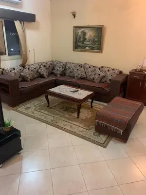 a living room with a couch and a coffee table at شقة سكنية ذات طابع عائلى متميز بها كافة الامكانيات من فلتر ماء وواى فاى in Hurghada