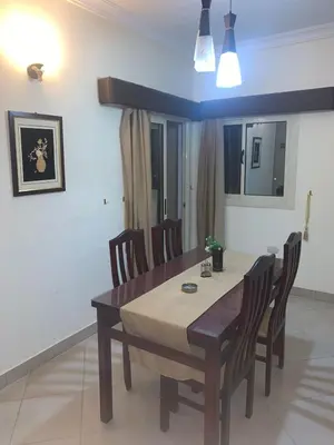 a dining room with a table and chairs at شقة سكنية ذات طابع عائلى متميز بها كافة الامكانيات من فلتر ماء وواى فاى in Hurghada