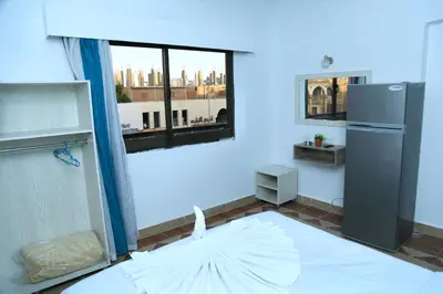 an empty room with a refrigerator and a window at Lamera Hotel in Hurghada