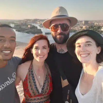 a group of people posing for a picture at the beach at Zekry nubian guest house in Aswan