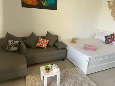 a living room with a couch and a bed at Cozy studio in G cribs in Hurghada