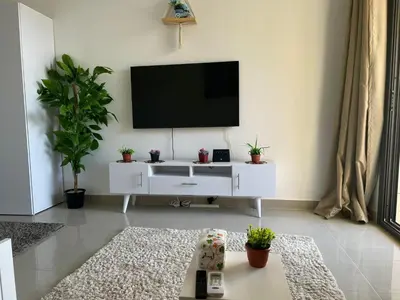 a living room with a flat screen tv on a wall at Cozy studio in G cribs in Hurghada