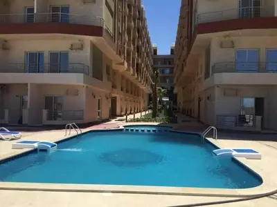 a large swimming pool in front of a building at كذا بلانكا بيتش 220 in Hurghada