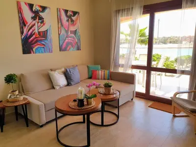 a living room with a couch and two tables at Brand New Waterfront Sabina Ground Floor Home in Hurghada