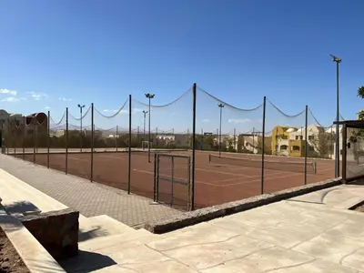 a tennis court with nets on a tennis court at Makadi heights luxury complex in Hurghada