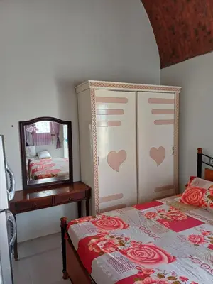 a bedroom with a bed and a dresser and a mirror at Sunny sea in Quseir