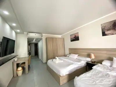 a hotel room with two beds and a flat screen tv at Scandic resort in Hurghada