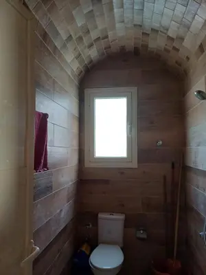 a small bathroom with a toilet and a window at Sunny sky in Quseir