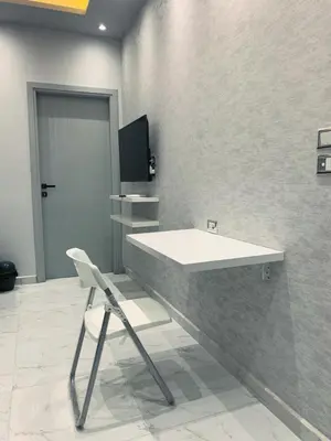 a bathroom with a white sink and a chair at BS Lodging 16- Next to Dream Beach in Hurghada