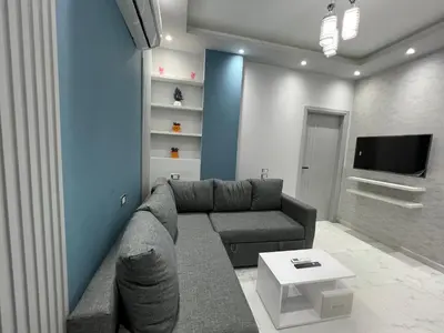 a living room with a couch and a tv at BS Lodging 16- Next to Dream Beach in Hurghada