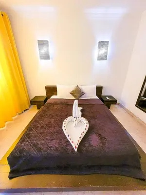 a bedroom with a bed with a heart on it at Sun Of Marina in Hurghada